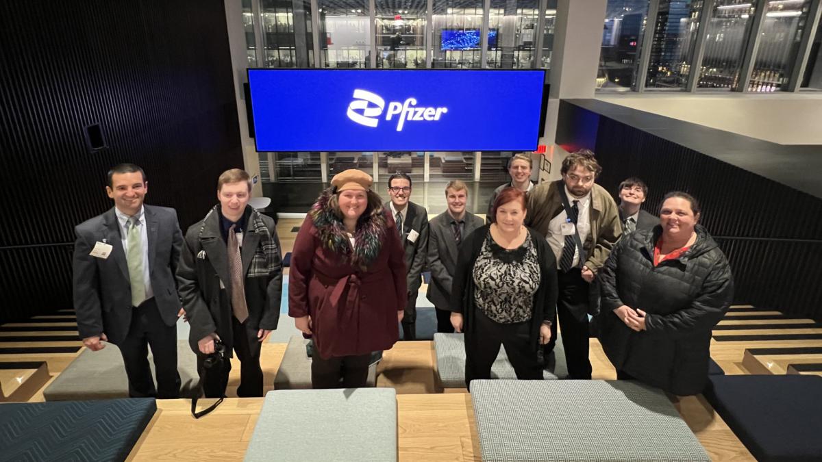 AIM Ƶapps posing for a group photo at Pfizer